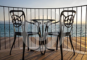 Terrace lake view with iron chairs and table