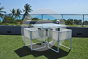 Terrace lounge with white rattan armchairs