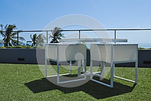 Terrace lounge with white rattan armchairs