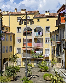 Terrace with stone planters and four story lampost in Nice, France
