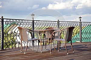 Terrace with table and chairs. interior of a summer cafe, rattan furniture in a rustic style.