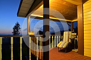 Terrace of wooden house in village at sunset