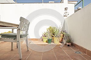 Terrace with wooden table and white chairs, several