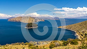 Terraced landscape of Isla del Sol with Andes mountains in the background on the Bolivian side of Lake Titicaca