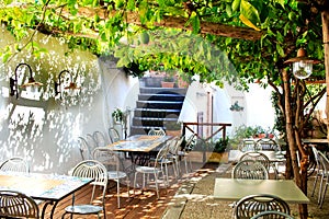 Terraced patio of the italian restaurant under lemon tree in Amalfi town