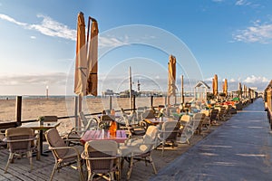 Terraces along the Dutch beach with a view at the Pier of Scheveningen