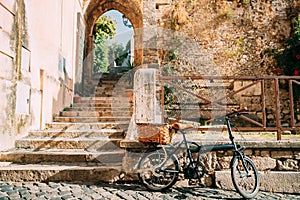 Terracina, Italy. Single Bicycle Bike With Basket Parking On Street Near Old Building