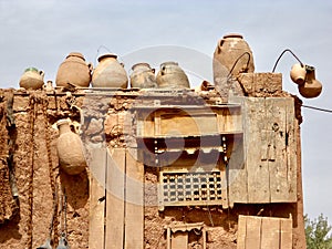 Terracotta amphorae and clay house photo