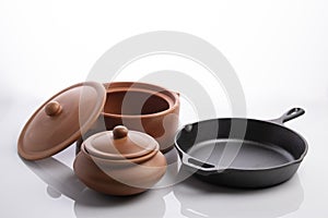 Terracotta Earthen Pots And Cast Iron Skillet  Isolated on White Background