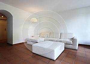 Terracotta floors and white sofa