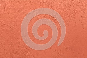 Terracotta painted stucco wall. Background texture