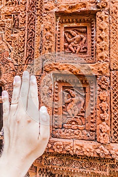 Terracotta panels and a human handat Govinda temple in Puthia village, Banglade