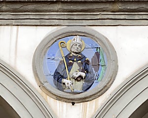 Terracotta relief of a Franciscan saint by Andrea della Robbia in a spandrel of the Hospital of San Paolo in Florence, Italy.