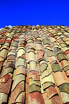 Terracotta roof on blue summer sky