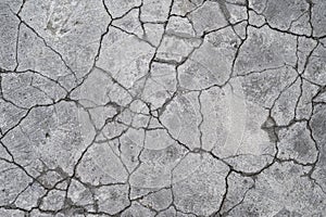 Terrain road with small rocks and cracks on the concrete.