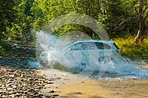 Terrain vehicle crosses the stream