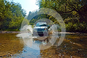 Terrain vehicle crosses the stream