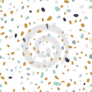 Terrazzo texture or tile. Seamless pattern with blue, yellow and black mineral rock crumb scattered on white background photo