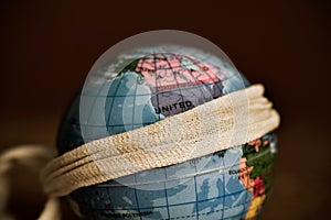 Terrestrial globe with a piece of cloth tied around it