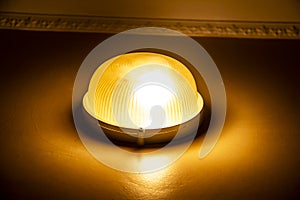 A Terrible light on the wall. The old lamp on the wall with yellow light