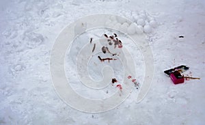 A terrible ugly snowman sculpted from the snow by children