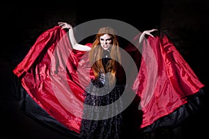 Terrible vampire woman in red cloak