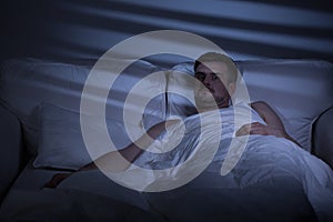 Terrified man in bed