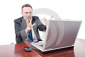 Terrified manager seeing something on laptop and screaming
