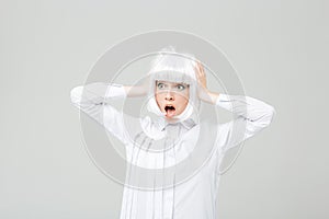 Terrified shocked woman with hands on head standing and shouting