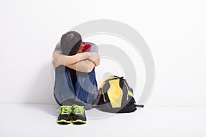 Terrified student sitting on the floor