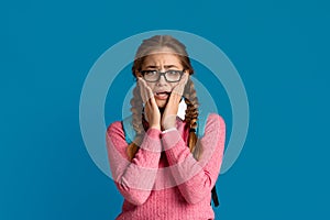 Terrified teenager girl in glasses, empty space