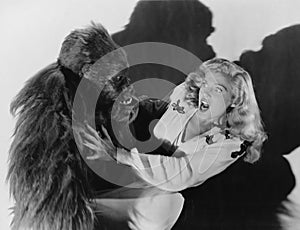 Terrified woman being attacked by gorilla photo