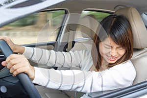 Terrified woman driving and having car accident or crash something.