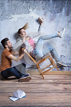 Terrified woman on toppling chair photo