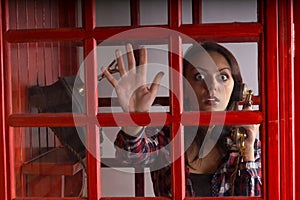 Terrified woman trapped in a telephone booth