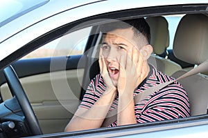 Terrified young male driver feeling guilty