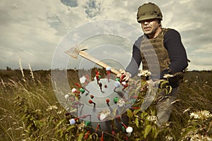 Territorial army member fighting with model of coronavirus virion outdoor on meadow