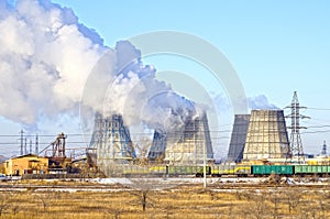 Territory of heat and power station. Accumulator tanks and cooling towers. Winter. Russia