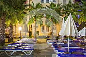 Territory resort hotel at night. Palms and beds in a tropical hotel night scene. Eftalia Resort hotel in Turkey