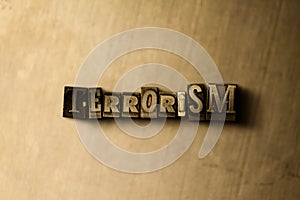 TERRORISM - close-up of grungy vintage typeset word on metal backdrop
