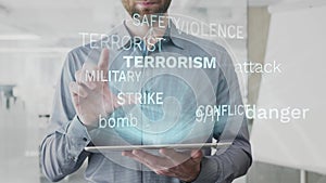 Terrorism, danger, attack, bomb, dread word cloud made as hologram used on tablet by bearded man, also used animated