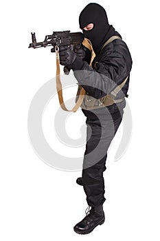 Terrorist in black uniform and mask with kalashnikov