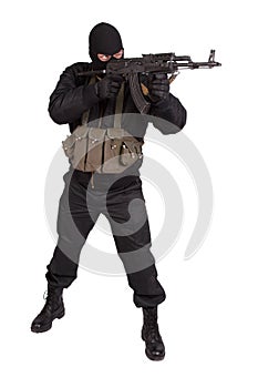 Terrorist in black uniform and mask with kalashnikov isolated