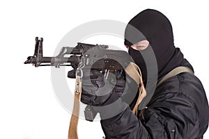 Terrorist in black uniform and mask with kalashnikov isolated