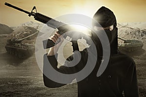 Terrorist with gun and military vehicle