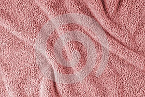 Terry cloth, red towel texture background. Soft fluffy textile bath or beach towel material