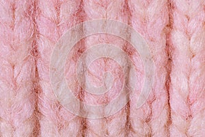 Terry knitted texture as a macro photo background. Pink and beige detail of a knitted item