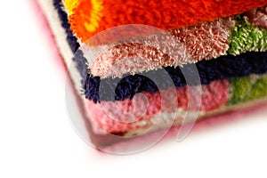 Terry towels of different colors. Closeup. Isolated on a white b