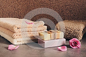 Terry towels, handmade soap, loofah sponge and rose petals. Set of bath and spa accessories