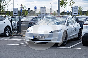 Tesla model y electric car on Free charging station, Tesla-Supercharger v4 Lounge, Power Charger ev in Europe, technology and
